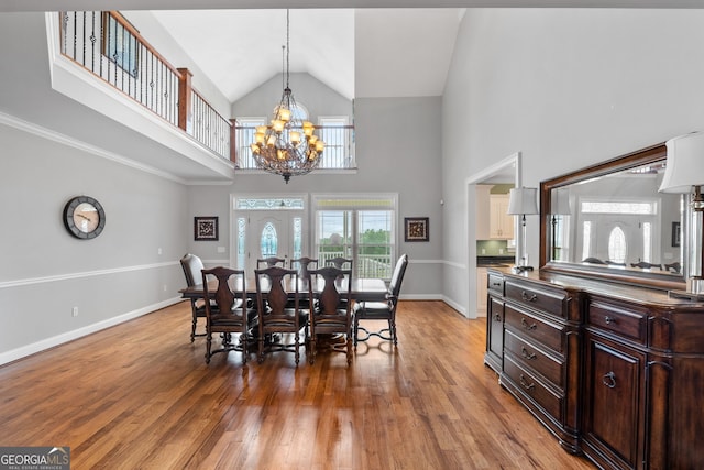 735 Firetower Rd, Thomaston, GA 30286 - dining space with light wood-type flooring, high vaulted ceiling, and a chandelier