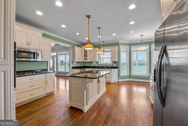 735 Firetower Rd, Thomaston, GA 30286 - kitchen with appliances with stainless steel finishes, crown molding, dark countertops, dark wood-type flooring, and glass insert cabinets