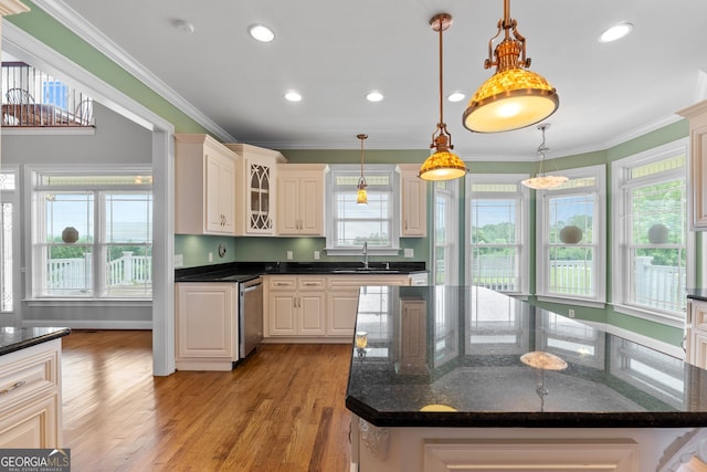 735 Firetower Rd, Thomaston, GA 30286 - kitchen featuring stainless steel dishwasher, light wood-style floors, crown molding, glass insert cabinets, and hanging light fixtures