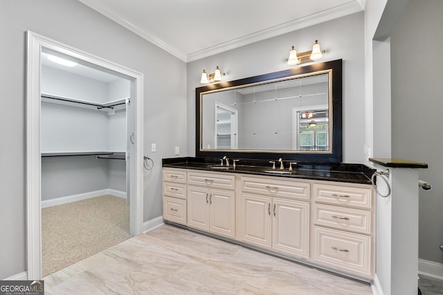 735 Firetower Rd, Thomaston, GA 30286 - bathroom featuring vanity, crown molding, and a walk in closet