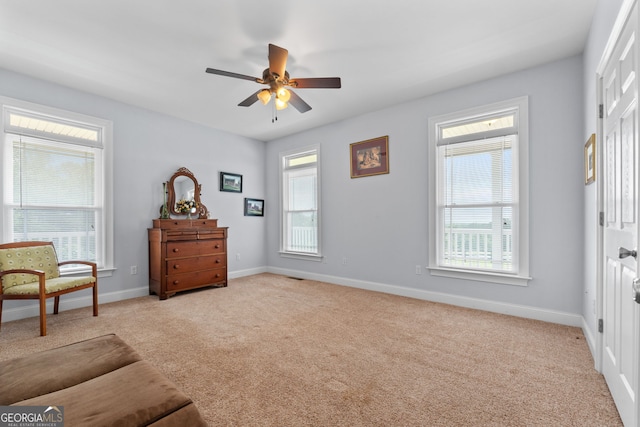 735 Firetower Rd, Thomaston, GA 30286 - sitting room with light colored carpet, plenty of natural light, and a ceiling fan