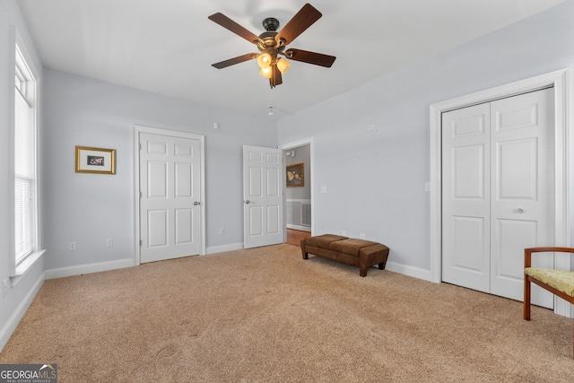735 Firetower Rd, Thomaston, GA 30286 - unfurnished bedroom featuring carpet, multiple windows, a closet, and a ceiling fan