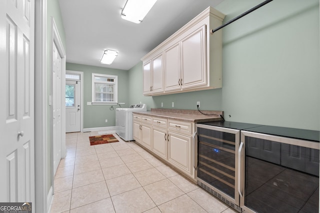 735 Firetower Rd, Thomaston, GA 30286 - washroom featuring washer / clothes dryer, beverage cooler, cabinet space, and light tile patterned floors