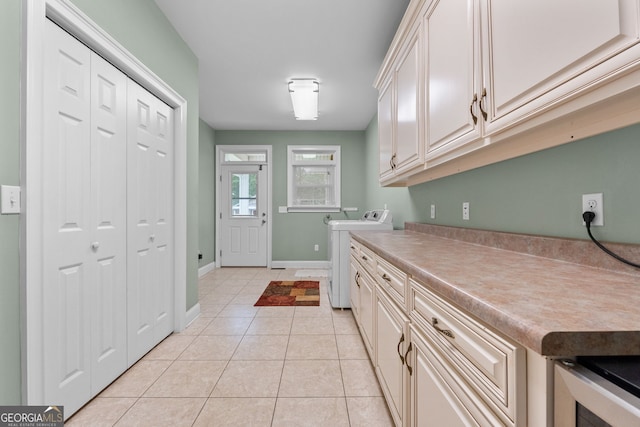 735 Firetower Rd, Thomaston, GA 30286 - washroom featuring washer / dryer, cabinet space, and light tile patterned floors
