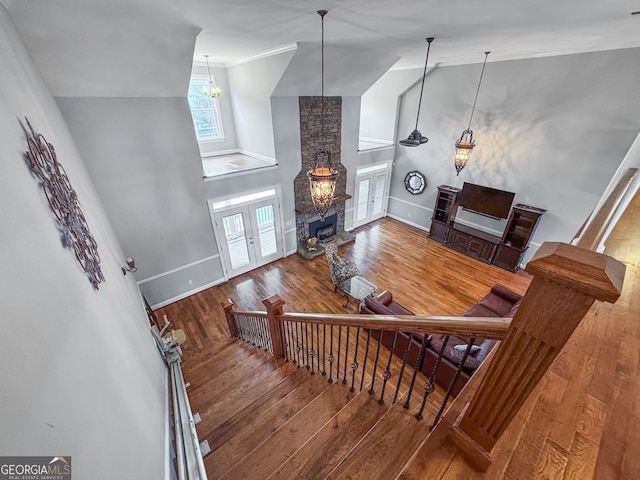 735 Firetower Rd, Thomaston, GA 30286 - staircase featuring a fireplace, wood finished floors, and high vaulted ceiling