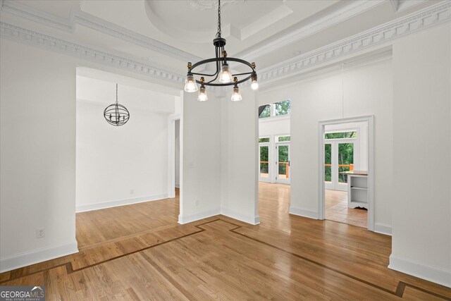 85 Geralds Pt, Wedowee, AL 36278 - unfurnished dining area with a chandelier, ornamental molding, wood finished floors, and a towering ceiling