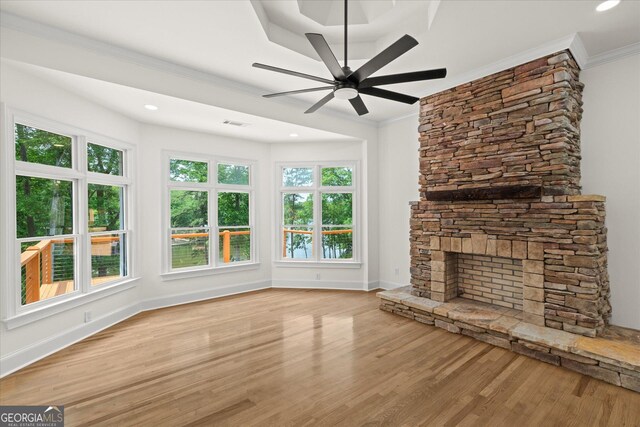 85 Geralds Pt, Wedowee, AL 36278 - unfurnished living room featuring wood finished floors, a ceiling fan, ornamental molding, a stone fireplace, and recessed lighting