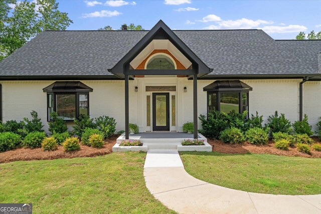 85 Geralds Pt, Wedowee, AL 36278 - view of front of home with brick siding, roof with shingles, and a front yard