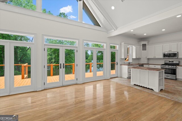 85 Geralds Pt, Wedowee, AL 36278 - kitchen featuring stainless steel appliances, french doors, high vaulted ceiling, white cabinetry, and beamed ceiling