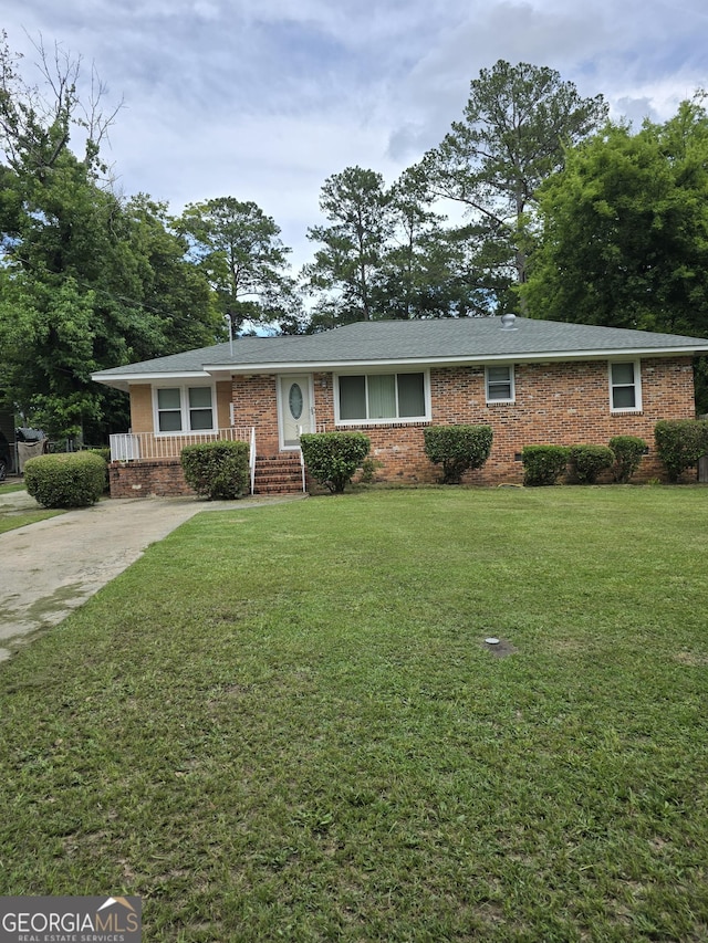 4322 Summerhill Dr, Macon, GA 31204 - ranch-style home with brick siding, a front yard, and concrete driveway