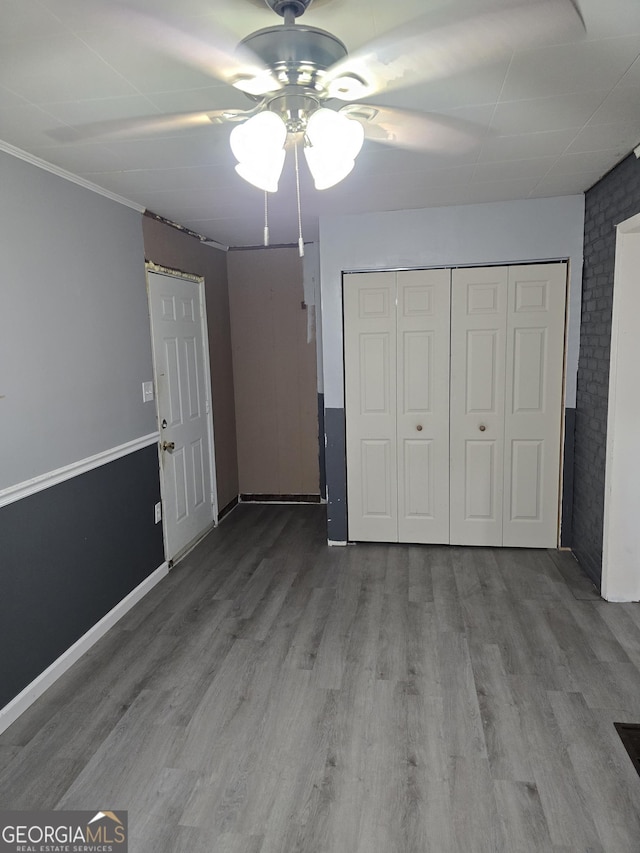 4322 Summerhill Dr, Macon, GA 31204 - unfurnished bedroom with wood finished floors, ceiling fan, and a closet