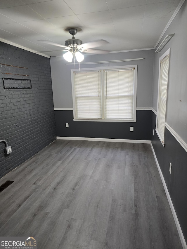 4322 Summerhill Dr, Macon, GA 31204 - spare room featuring ceiling fan, wood finished floors, brick wall, and crown molding