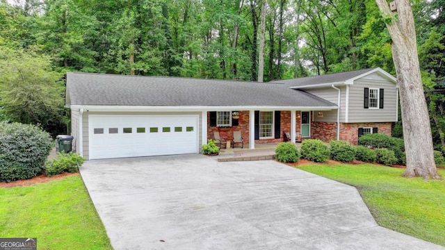 595 Glenforest Rd, Sandy Springs, GA 30328 - tri-level home with covered porch, concrete driveway, brick siding, an attached garage, and a front yard