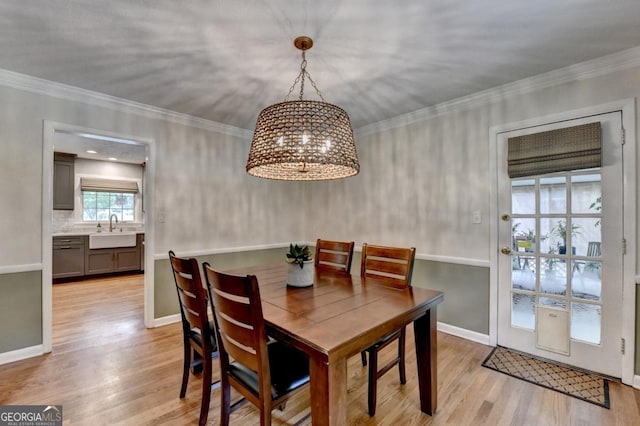 595 Glenforest Rd, Sandy Springs, GA 30328 - dining room with a chandelier, light wood-style floors, and crown molding