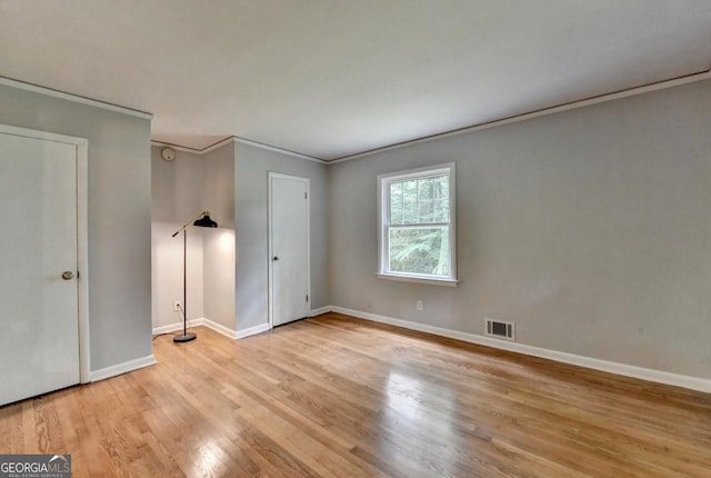 595 Glenforest Rd, Sandy Springs, GA 30328 - unfurnished bedroom featuring light wood-style floors and ornamental molding