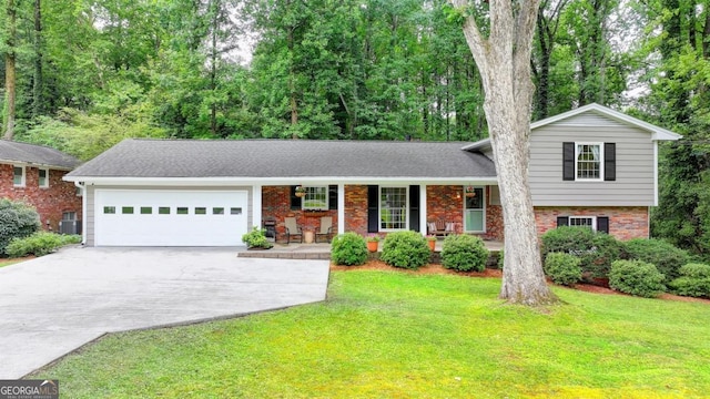 595 Glenforest Rd, Sandy Springs, GA 30328 - tri-level home with an attached garage, driveway, covered porch, and brick siding