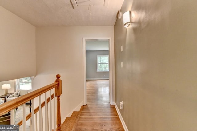 595 Glenforest Rd, Sandy Springs, GA 30328 - corridor featuring attic access, light wood-style floors, and an upstairs landing