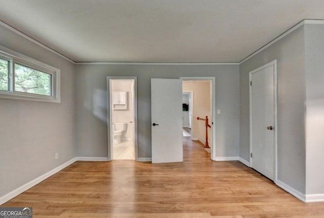 595 Glenforest Rd, Sandy Springs, GA 30328 - unfurnished bedroom featuring light wood-style floors, ornamental molding, and connected bathroom
