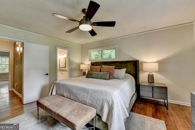595 Glenforest Rd, Sandy Springs, GA 30328 - bedroom with multiple windows, wood finished floors, a ceiling fan, and ensuite bathroom