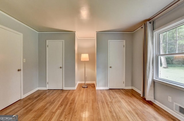 595 Glenforest Rd, Sandy Springs, GA 30328 - unfurnished bedroom featuring light wood-style flooring and crown molding