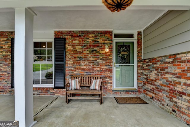 595 Glenforest Rd, Sandy Springs, GA 30328 - view of exterior entry featuring covered porch and brick siding