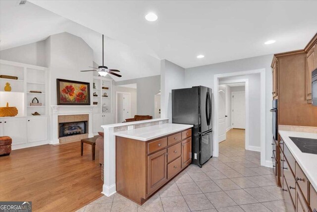 6 Majestic Oaks Way NE, Rome, GA 30165 - kitchen featuring black appliances, light countertops, brown cabinets, vaulted ceiling, and a ceiling fan