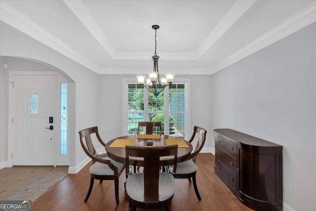 6 Majestic Oaks Way NE, Rome, GA 30165 - dining area with a chandelier, arched walkways, wood finished floors, and a tray ceiling