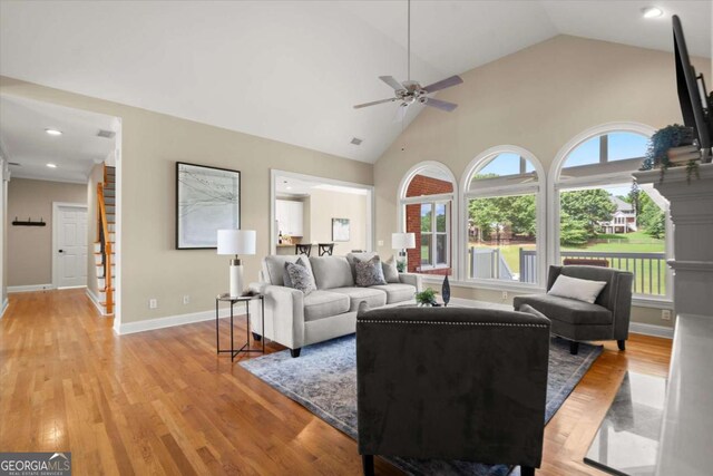 411 Hickory Fairway Ct, Woodstock, GA 30188 - living area featuring a ceiling fan, light wood-style floors, high vaulted ceiling, stairway, and recessed lighting