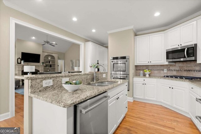 411 Hickory Fairway Ct, Woodstock, GA 30188 - kitchen featuring appliances with stainless steel finishes, ornamental molding, backsplash, white cabinetry, and recessed lighting