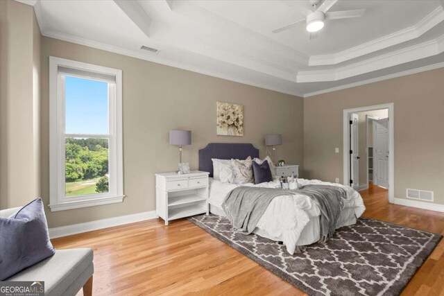 411 Hickory Fairway Ct, Woodstock, GA 30188 - bedroom with a tray ceiling, ornamental molding, and wood finished floors