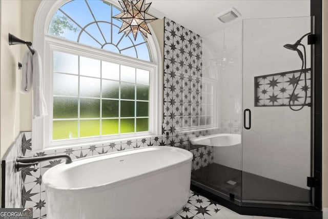 411 Hickory Fairway Ct, Woodstock, GA 30188 - bathroom featuring a soaking tub, tile walls, a stall shower, and tile patterned flooring