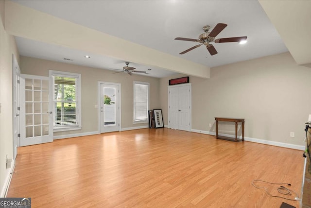 411 Hickory Fairway Ct, Woodstock, GA 30188 - unfurnished living room featuring ceiling fan and light wood-style floors