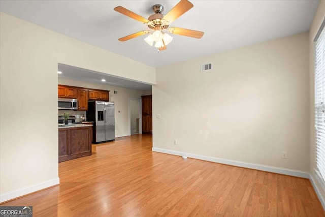 411 Hickory Fairway Ct, Woodstock, GA 30188 - unfurnished living room featuring light wood-type flooring and ceiling fan