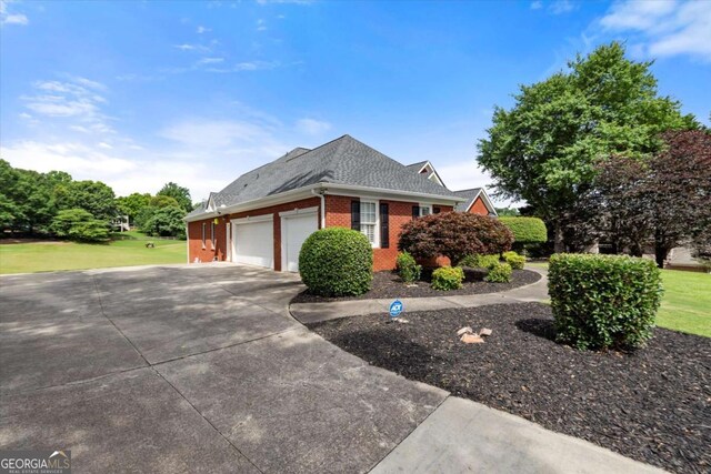 411 Hickory Fairway Ct, Woodstock, GA 30188 - view of front of property featuring brick siding, an attached garage, driveway, a shingled roof, and a front lawn