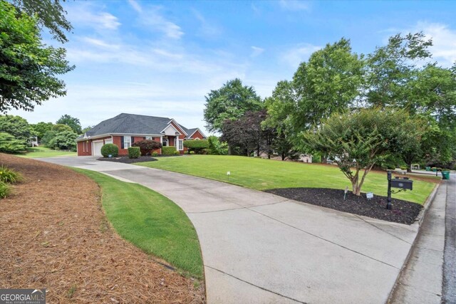 411 Hickory Fairway Ct, Woodstock, GA 30188 - view of community featuring a yard, an attached garage, and concrete driveway