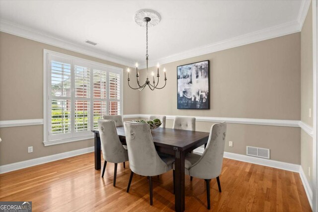411 Hickory Fairway Ct, Woodstock, GA 30188 - dining room featuring a chandelier, ornamental molding, and light wood-style flooring