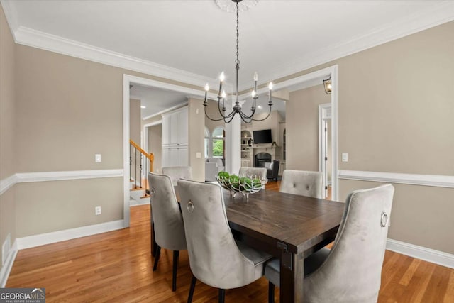 411 Hickory Fairway Ct, Woodstock, GA 30188 - dining room featuring a chandelier, wood finished floors, ornamental molding, and stairway