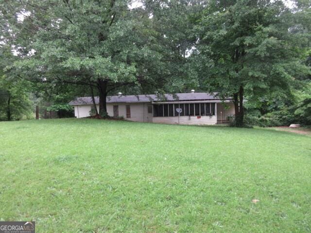 125 Highland Cir, Stockbridge, GA 30281 - view of green lawn featuring a sunroom