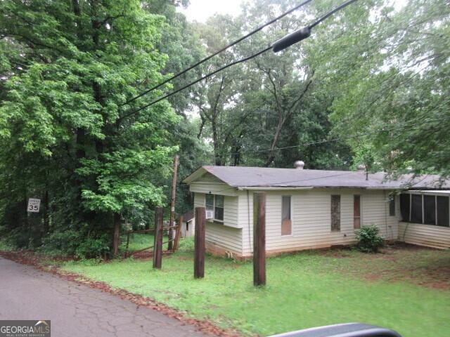 125 Highland Cir, Stockbridge, GA 30281 - view of home's exterior featuring a lawn