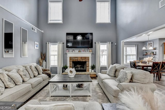 1811 Alberta Ln, Winder, GA 30680 - living room with a towering ceiling, wood finished floors, and a stone fireplace