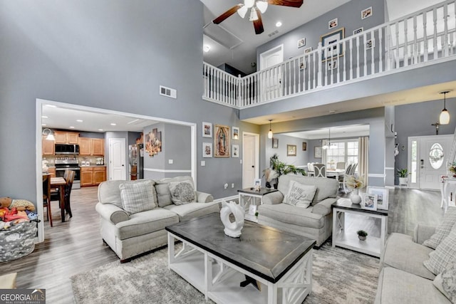 1811 Alberta Ln, Winder, GA 30680 - living room with a high ceiling, a ceiling fan, light wood-style flooring, and recessed lighting