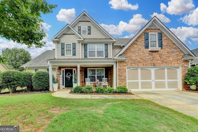 1811 Alberta Ln, Winder, GA 30680 - craftsman-style house with concrete driveway, a porch, a front yard, and stone siding