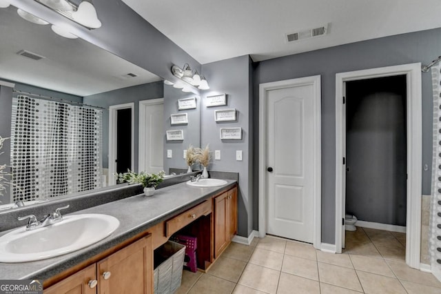 1811 Alberta Ln, Winder, GA 30680 - bathroom with double vanity and tile patterned floors