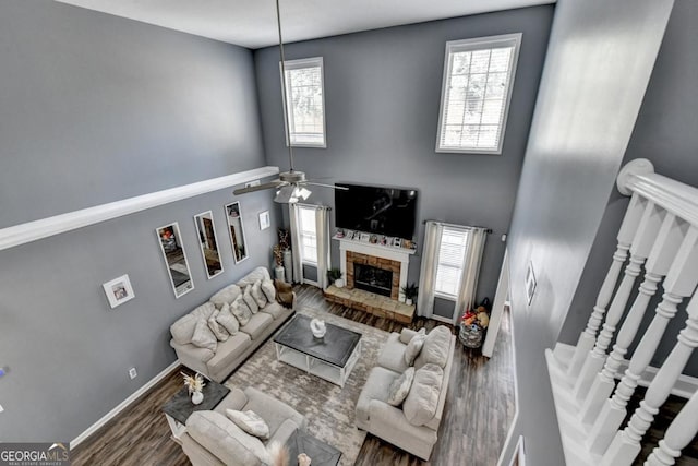 1811 Alberta Ln, Winder, GA 30680 - living area featuring plenty of natural light, wood finished floors, a fireplace, ceiling fan, and a towering ceiling
