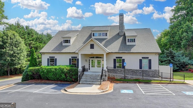 1811 Alberta Ln, Winder, GA 30680 - view of front facade featuring french doors, uncovered parking, a chimney, and a shingled roof