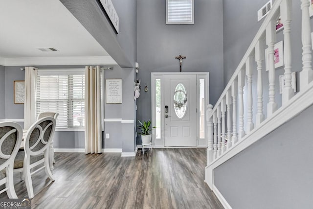 1811 Alberta Ln, Winder, GA 30680 - foyer featuring wood finished floors, a high ceiling, stairway, and ornamental molding