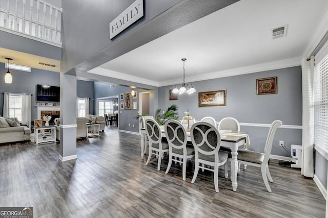 1811 Alberta Ln, Winder, GA 30680 - dining space with dark wood-style floors, ornamental molding, and a chandelier