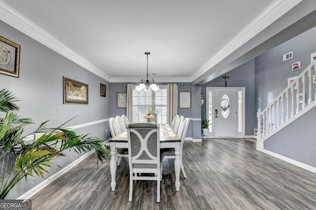 1811 Alberta Ln, Winder, GA 30680 - dining area featuring a chandelier, wood finished floors, ornamental molding, and stairs