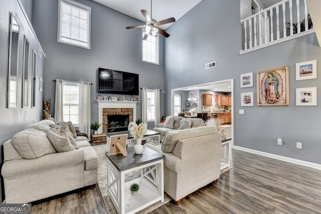 1811 Alberta Ln, Winder, GA 30680 - living area with a ceiling fan, high vaulted ceiling, a stone fireplace, wood finished floors, and plenty of natural light