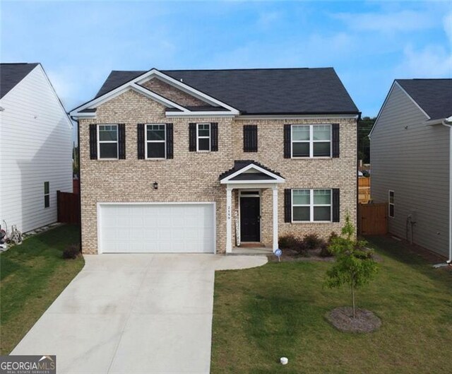 2159 Redfern, Dacula, GA 30019 - view of front of house featuring an attached garage, brick siding, and driveway